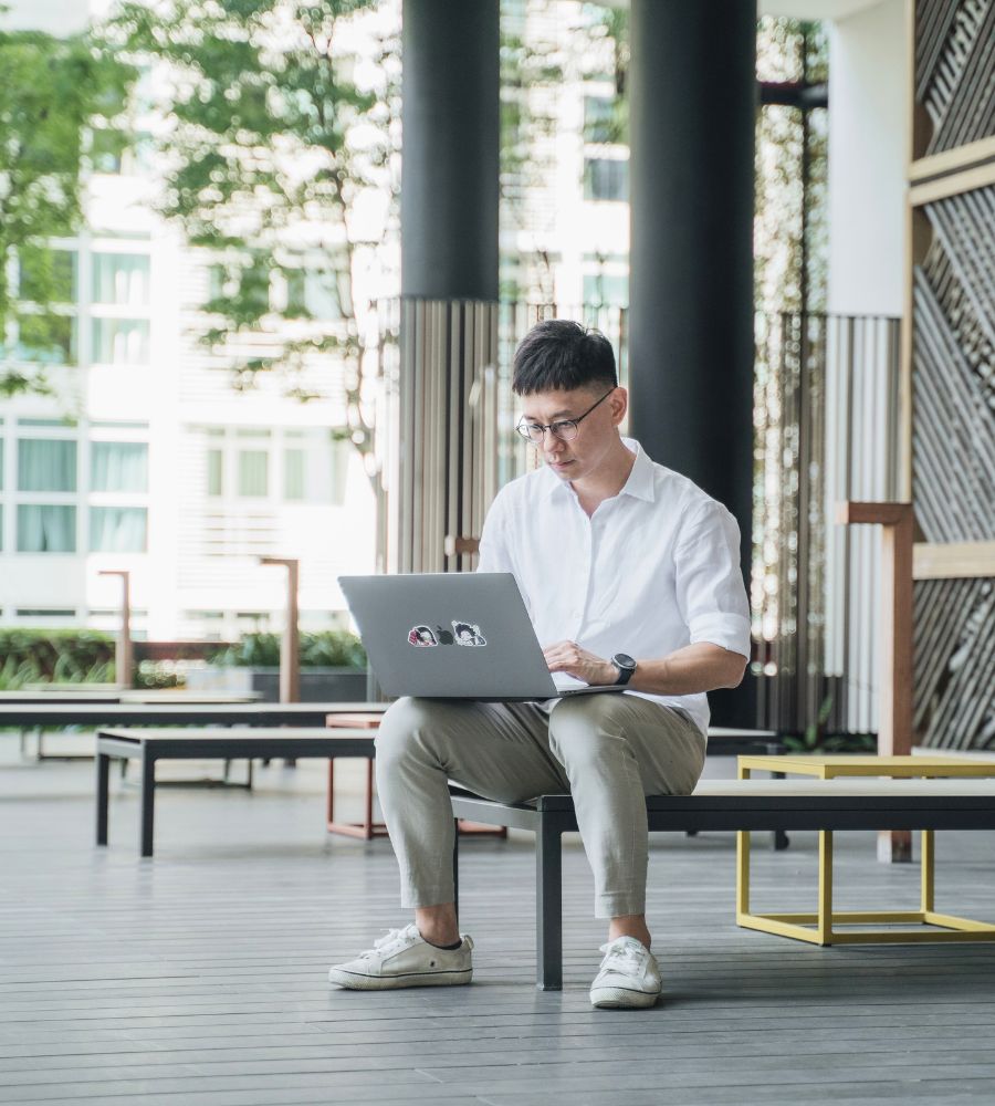 YY Sng working on a laptop